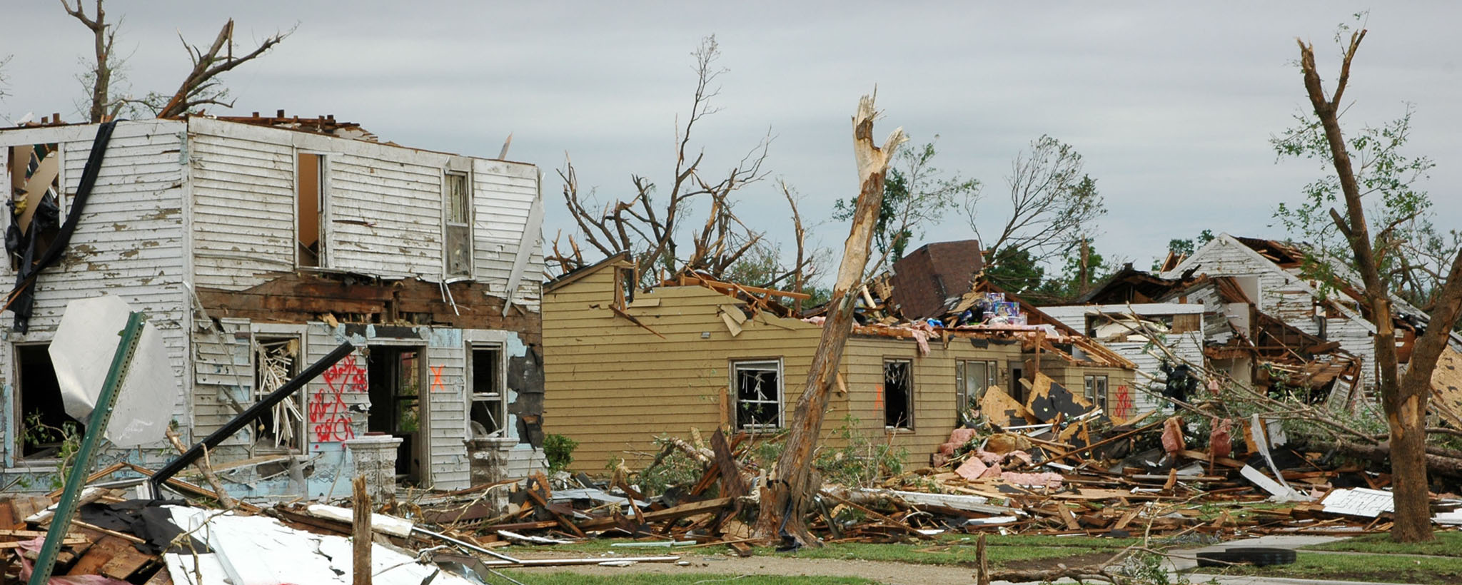 Three houses severely damaged from a tornado.
