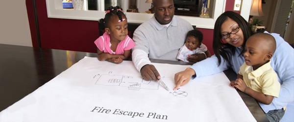 A family with young children makes a fire escape plan.