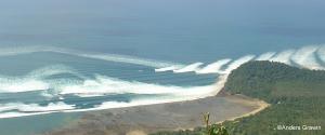 View of tsunami waves hitting a shoreline. View of tsunami waves hitting a shoreline.