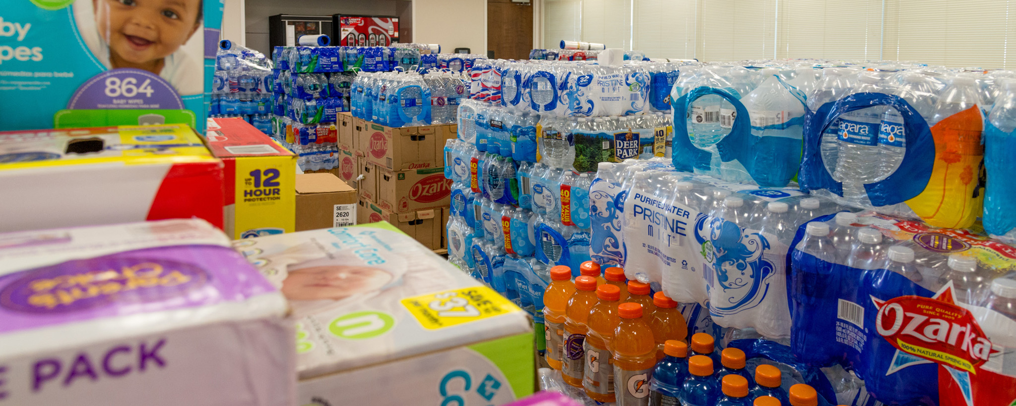 A  donation center filled with Gatorade, water, and diapers
