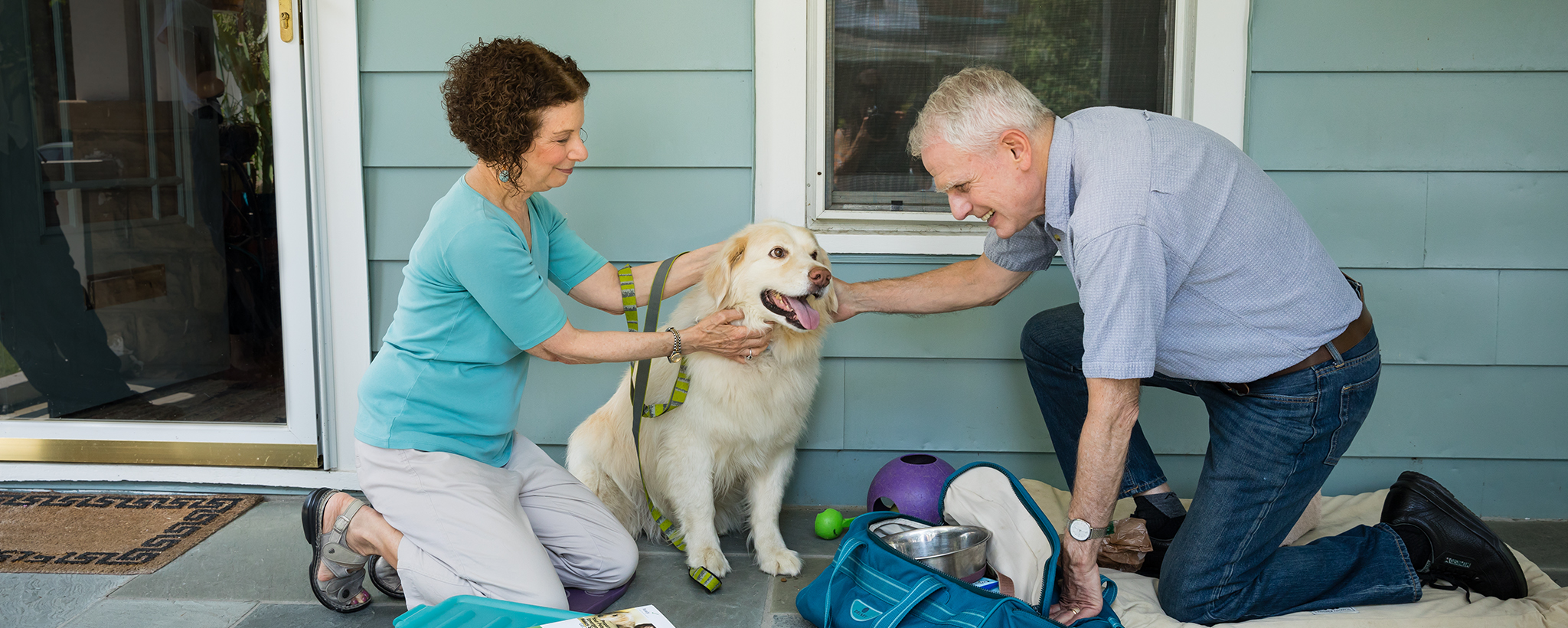 An older couple prepares a kit for their dog, sitting near them