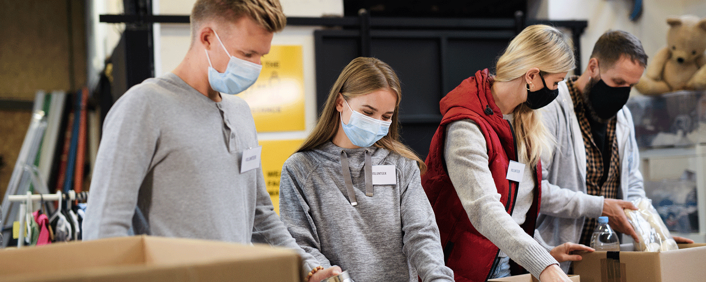 Volunteers packing boxes with canned goods