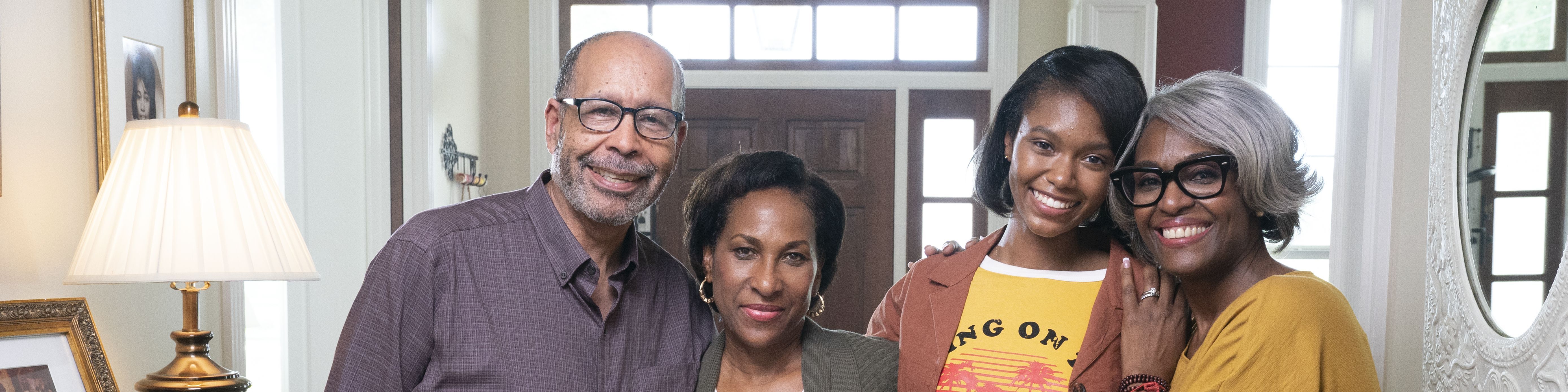 A black family stands together in their home