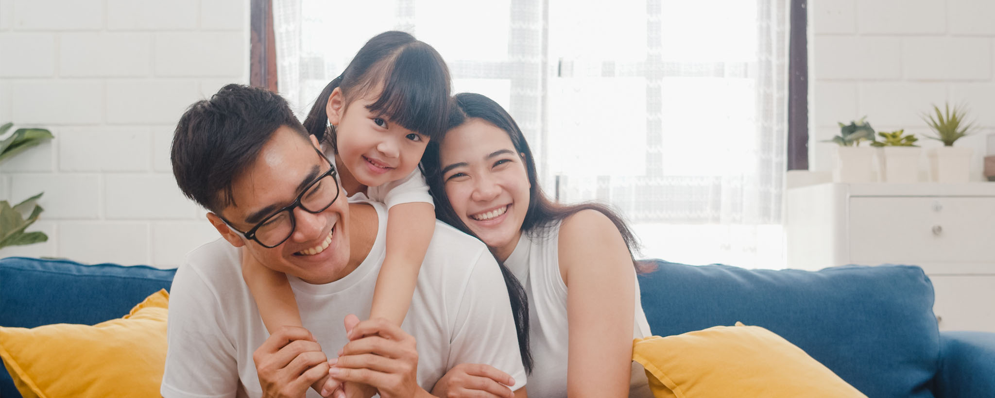 Asian family sitting together on a couch