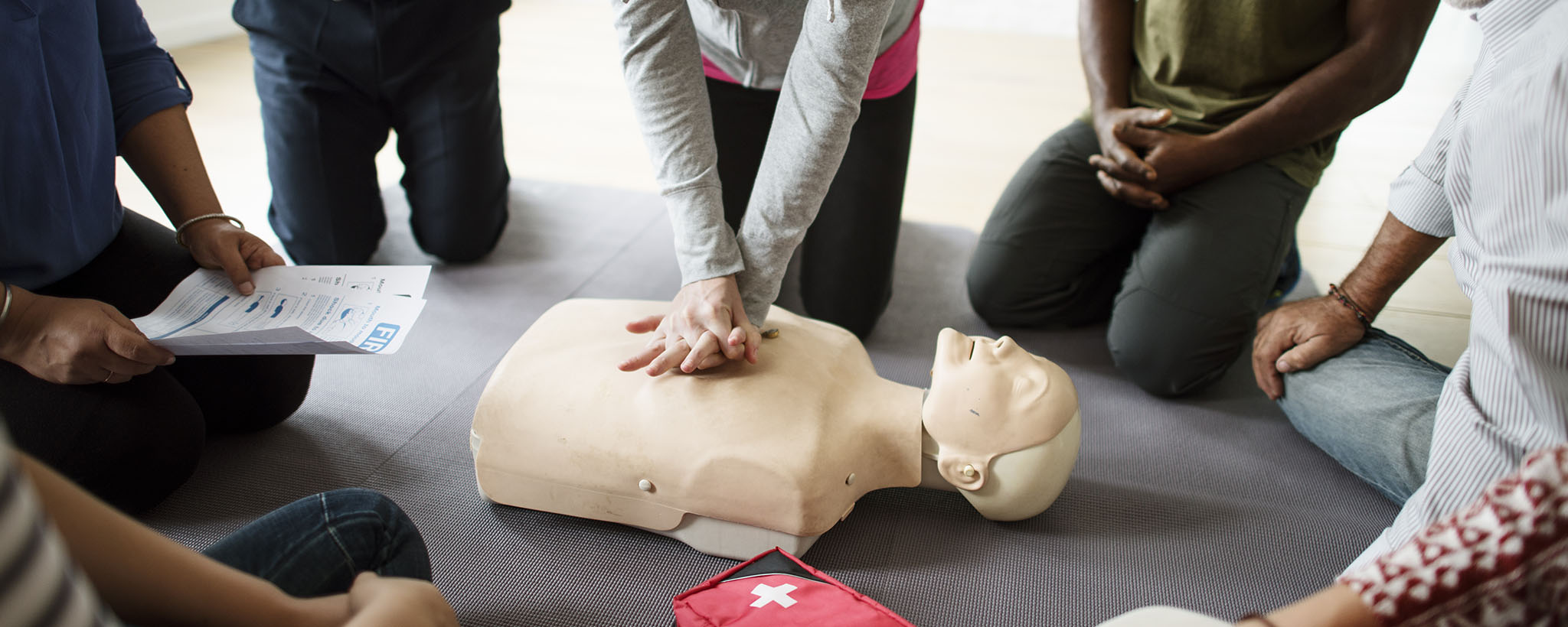 People learning CPR on a dummy. 