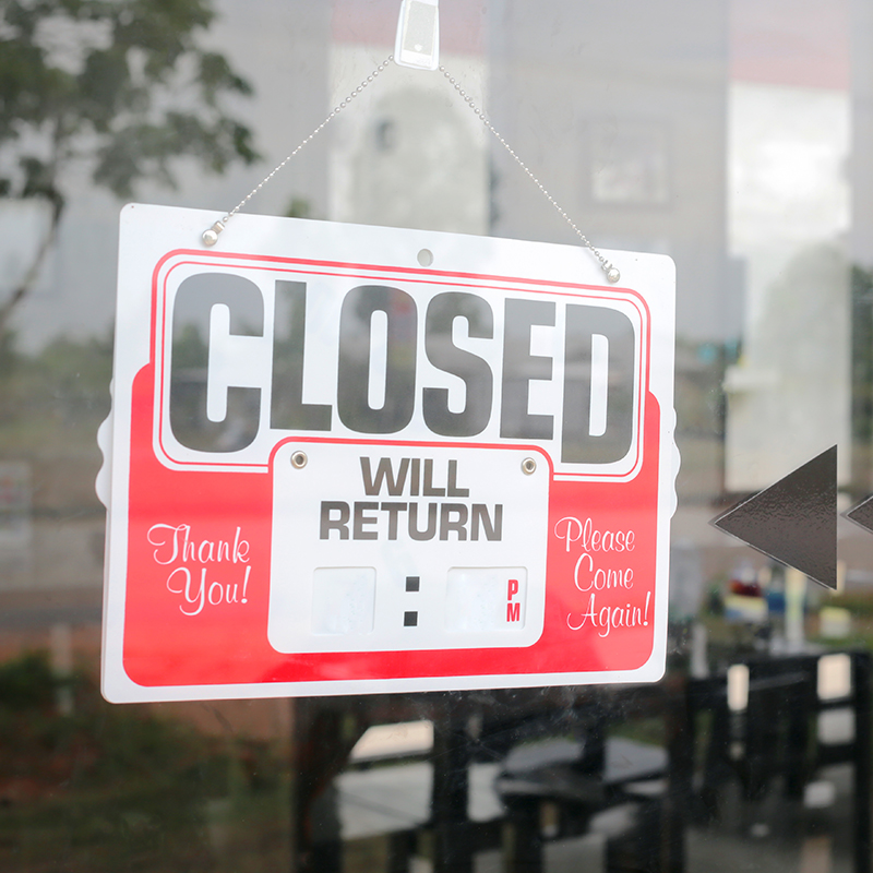 a closed sign in a business storefront