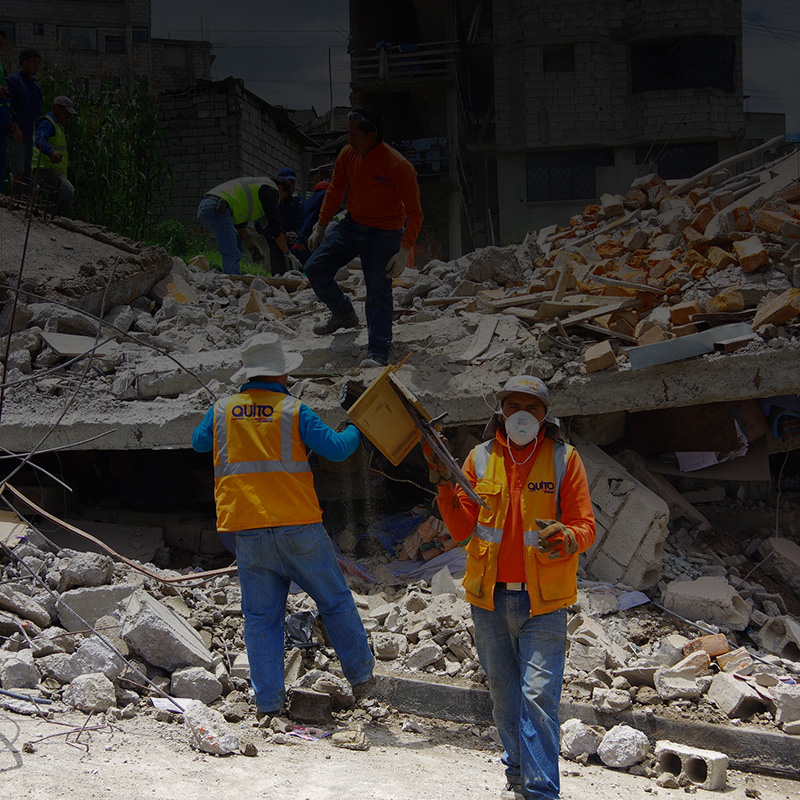 Workers search for earthquake survivors in rubble.