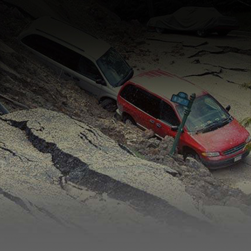picture of two cards on a cracked hilly road after a landslide