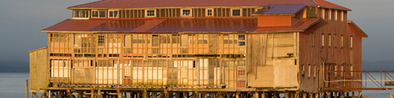 Sept 28th, 2009. A tuna cannery, built on stilts, sits over the calm shore.