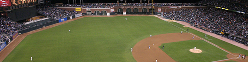 October 16th, 1989. An aerial view of a baseball field with players in the outfield anxiously wait as the pitch is thrown.