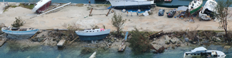 Dec. 8, 2002. The coastline is littered with fishing boats, many thrown on rocks and sand, others sunk in shallow waters.