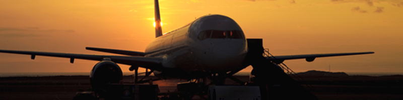 September 10th, 1992. A plane is sitting on the runway at sunset.