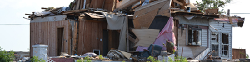 May 22nd, 2011. A single family home lays in shambles as drywall and kitchen cabinets are exposed.