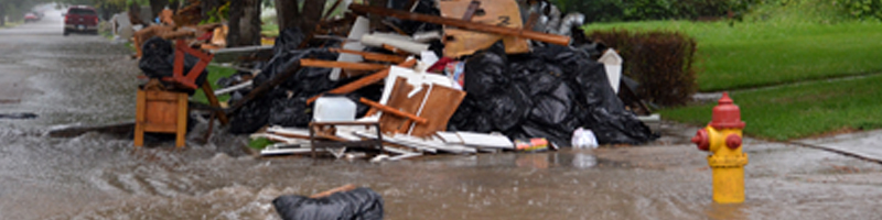 June 23rd, 2011. A pile of furniture is on the sidewalk with rain waters covering the streets. June 23rd, 2011. A pile of furniture is on the sidewalk with rain waters covering the streets.