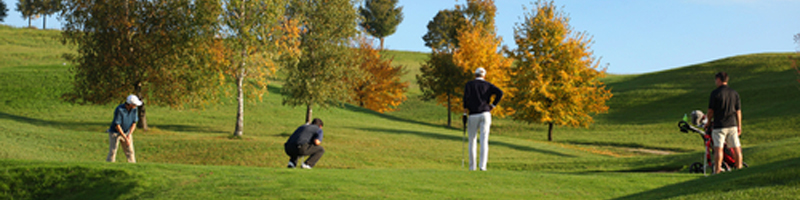 September 23rd, 2005. A group of golfers on the green. One of them is getting ready to putt. September 23rd, 2005. A group of golfers on the green. One of them is getting ready to putt.