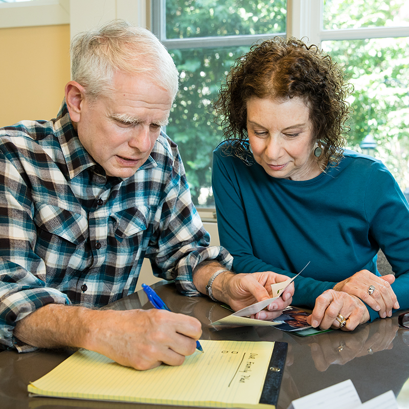 A senior couple makes an emergency plan using Ready materials.