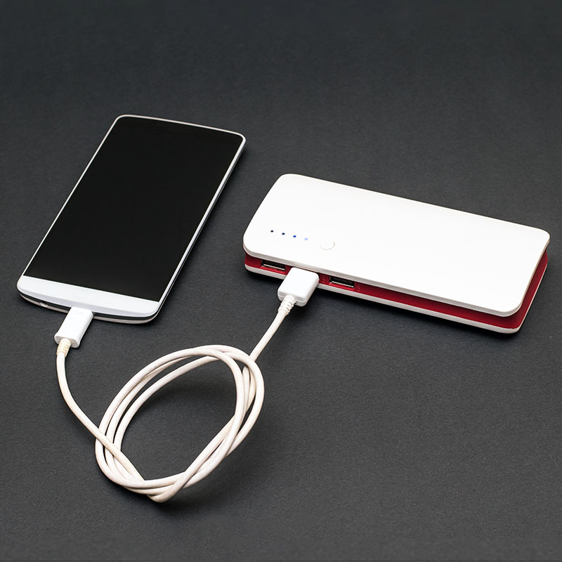 Cell phone plugged into a backup battery pack