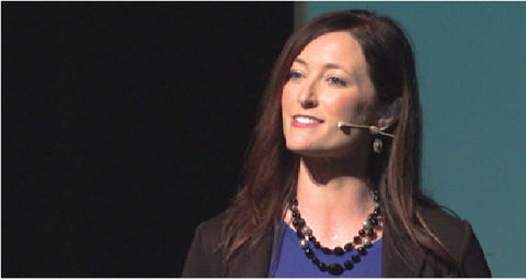A woman giving a prep talk with a microphone headset on