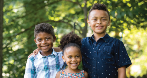 two brothers and a sister smile for the camera