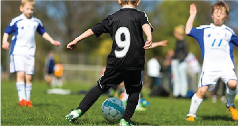 A youth soccer team plays on the field