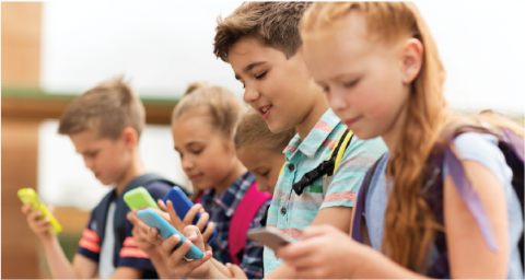 A line of school age kids on their smart phones