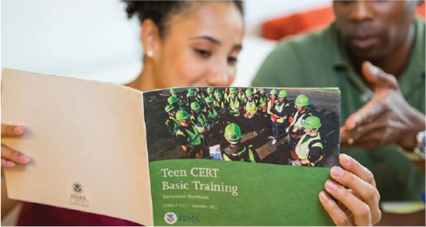 Teen looking at Teen CERT brochure
