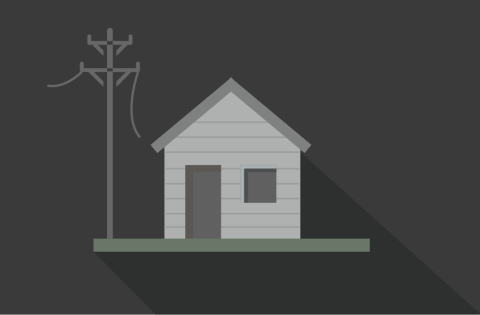 A house in the dark next to downed power lines