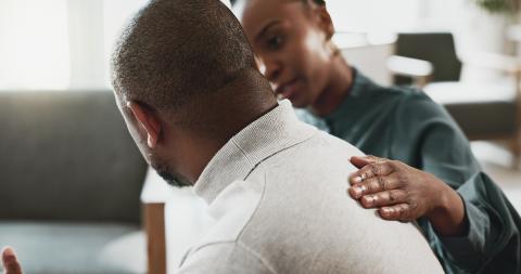 A man speaks with a counselor.