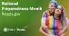 Two women wearing rainbow shirts hug. National Preparedness Month. 