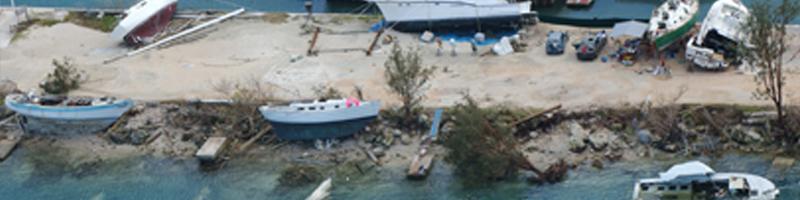 Dec. 8, 2002. The coastline is littered with fishing boats, many thrown on rocks and sand, others sunk in shallow waters.