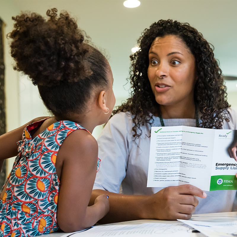 A mother making a communications plan with her young daughter.